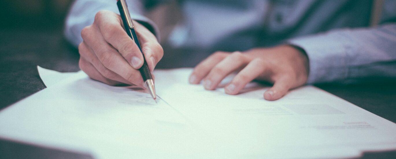 Calculator, documents, and budget notes used to estimate private investigator case costs